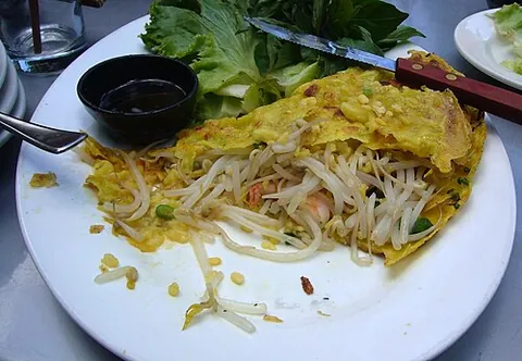 bánh xèo: vietnamese fried pancake made of rice flour, water, and turmeric powder, stuffed with slivers of...