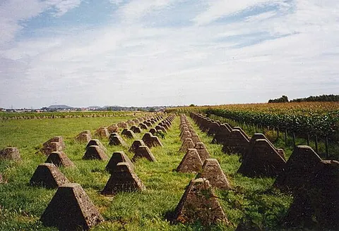 dragon's teeth: square-pyramidal fortifications of reinforced concrete to impede the movement of tanks and...