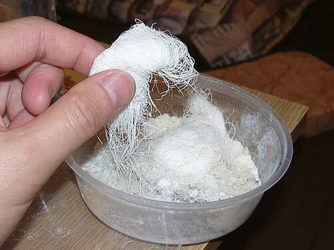 dragon's beard candy: a traditional Chinese sweet similar to halva or cotton candy made from fine white sugar, peanuts,...