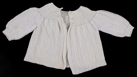 matinée jacket: a short coat for a baby, similar to a cardigan