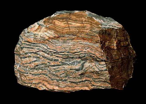 hälleflinta: a fine-grained rock consisting of an intimate mixture of quartz and feldspar, sometimes banded or...