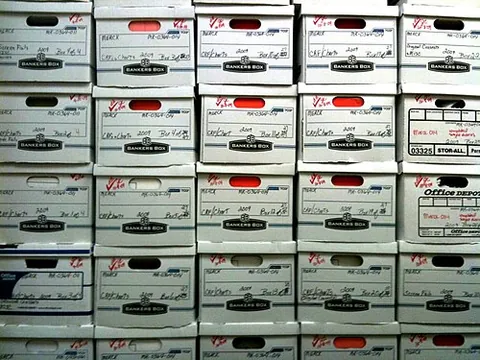 banker's box: a file box: a cardboard box designed to hold paper files