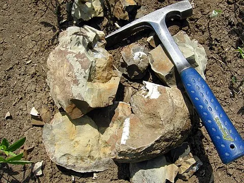 stonemason's hammer: a hammer with a flat face and a chisel-shaped blade for chipping off pieces of stone