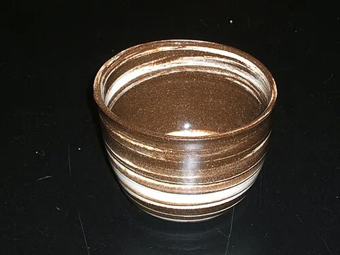 agateware: pottery decorated with a combination of contrastingly coloured clays, designed to resemble the...