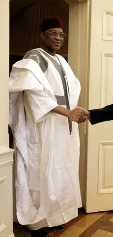 agbada: a long, flowing robe with wide sleeves worn by men in some parts of West Africa, often decorated...