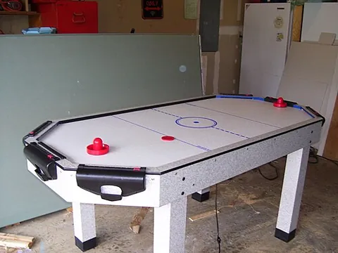 air hockey: a game, played upon a table which lightly spurts air out of various holes on its surface in order...