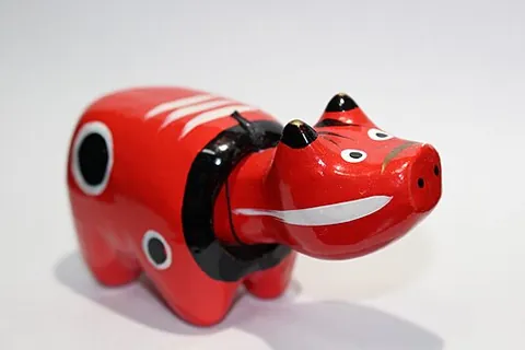 akabeko: a red papier-mâché bobblehead cow toy, a kind of regional omiyage regarded as symbolic of the Aizu...
