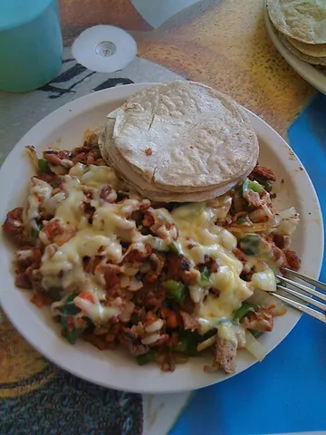 alambre: a Mexican dish, consisting of meat (usually grilled beef) topped with cheese, salsa, and chopped...