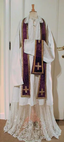 alb: a long, white robe worn by priests and other ministers, underneath most of the other vestments