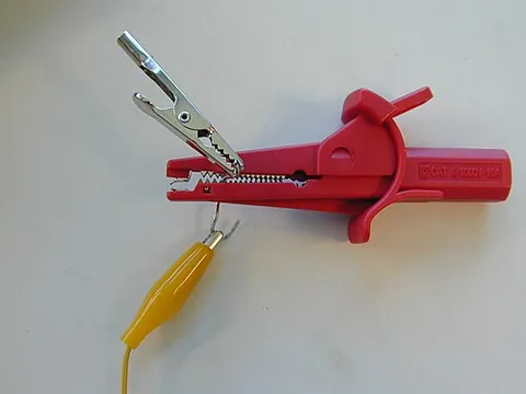 alligator clip: a spring-loaded metal clip, usually attached to a wire and used to create a temporary electrical...