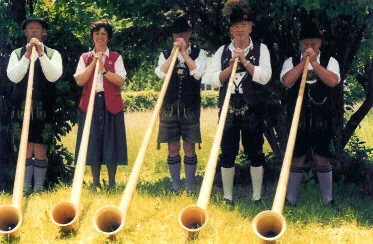 alphorn: a long, curved, wooden horn used by mountain-dwelling herders in the Alps, originally to call...