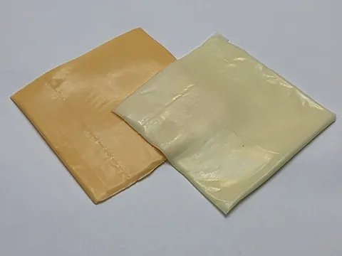 american cheese: a common processed cheese, yellow or white in color and mild in flavor, with a medium-firm...