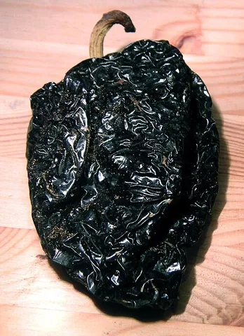 ancho: a broad, flat, dried poblano pepper, often ground into a powder