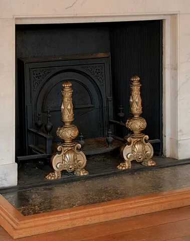 andiron: a utensil for supporting wood when burning in a fireplace, one being placed on each side