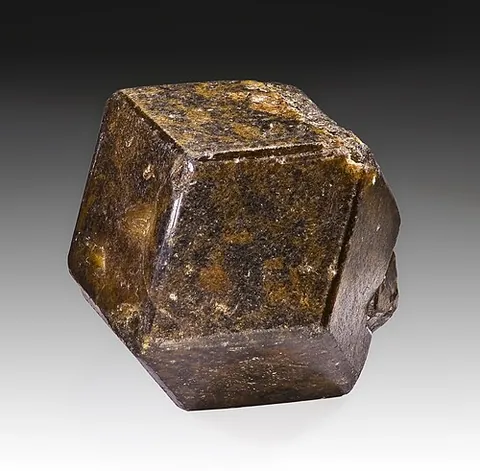 andradite: a nesosilicate mineral of the garnet group with chemical formula Ca₃Fe₂Si₃O₁₂