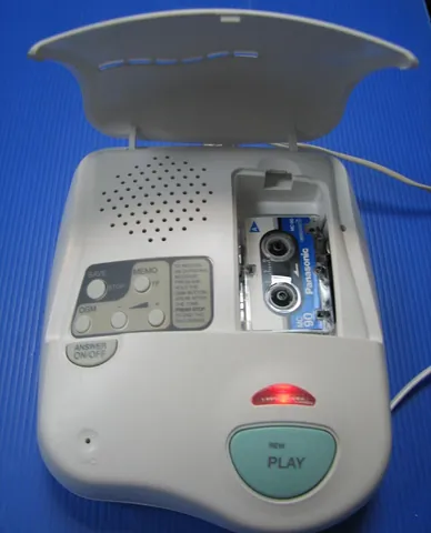 answering machine: a device that automatically records voicemails from unanswered telephone calls