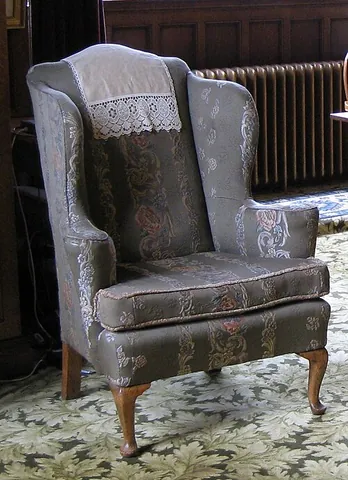 antimacassar: a cover for the back or arms of a chair or sofa