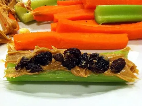 ants on a log: a snack made by spreading cream cheese, peanut butter, ricotta cheese or any number of spreads on...