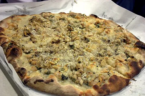 apizza: a style of pizza endemic to New Haven, Connecticut, incorporating a thin, oblong crust, charring,...