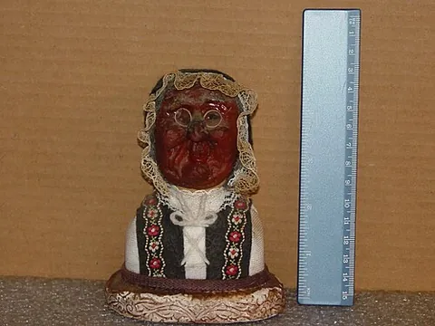 apple doll: a North American folkcraft doll having a head made from a dried apple