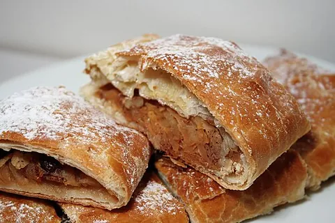 apple strudel: an Austrian pastry of apples, sugar, raisins, spice, etc in thin strudel dough or filo pastry