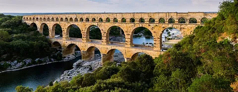 aqueduct: an artificial channel that is constructed to convey water from one location to another