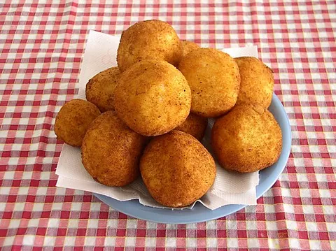 arancino: a baked rice ball, filled with cheese or other sauce, originally from Sicily