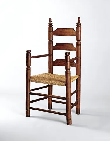 armchair: a chair with supports for the arms or elbows