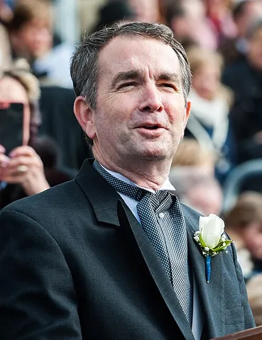 ascot tie: a type of cravat or necktie with a narrow neckband and wide wings laid one across the other