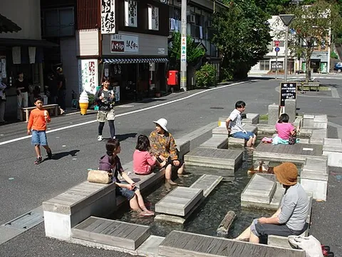 ashiyu: a shallow communal pool in Japan, usually with seats around it, filled with warm water in which...