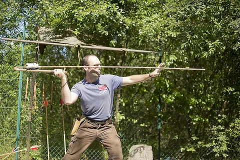 atlatl: a spearthrower consisting of a wooden stick with a thong or perpendicularly protruding hook on the...