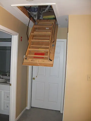 attic ladder: a usually retractable ladder used to access an attic through an attic door