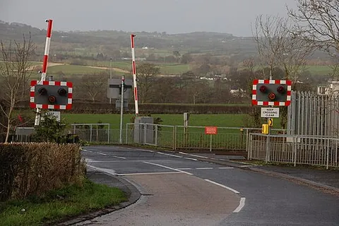 automatic half-barrier level crossing: a level crossing with a single barrier on each side of the railway line, the barriers when lowered...