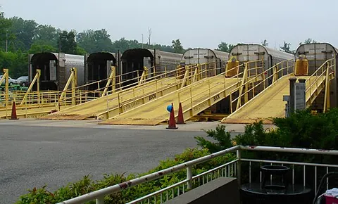 autorack: a railroad car designed for the transport of automobiles