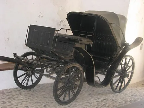 calèche: a type of carriage with low wheels, especially pulled by horses