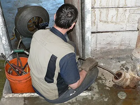 plumber's snake: a long, flexible tool, often with rotating blades at its forward end, which is inserted into a...