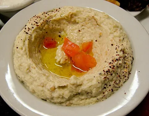 baba ganoush: a Middle Eastern dish made from a purée of roasted aubergine (eggplant), garlic, and tahini, often...