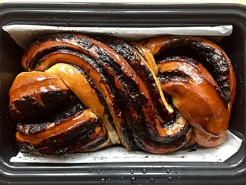 babka: a Central and Eastern European coffee cake flavored with orange rind, rum, almonds, and raisins; or...