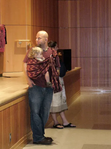 baby sling: a sling used to harness a child to an adult for restraint and transport