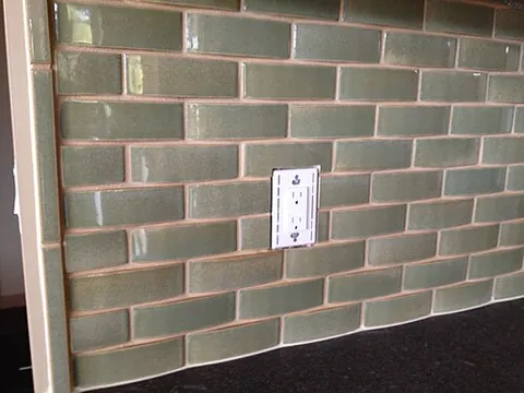 backsplash: a vertical covering on a wall rising above a countertop or other work surface to protect the wall...