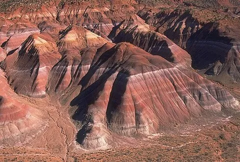badlands: an arid terrain characterized by severe erosion of sedimentary rocks