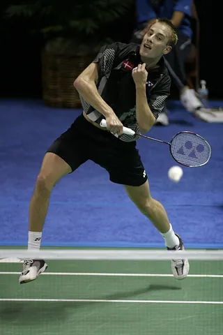 badminton: a racquet sport played indoors on a court by two opposing players (singles) or two opposing pairs...
