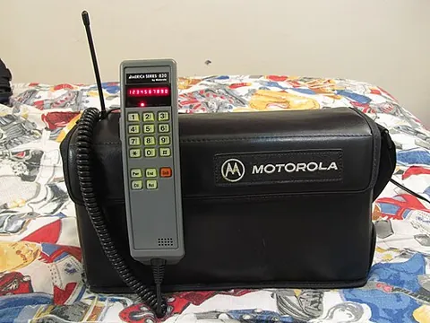 bag phone: an early mobile phone consisting of a handset attached by a cord to a bag containing a transceiver...