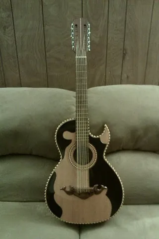 bajo sexto: a stringed instrument of Mexican origin, with twelve thick strings in six double-courses, with a...
