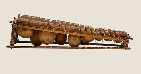 balafon: a wooden-keyed percussion idiophone of West Africa that is struck with two padded sticks