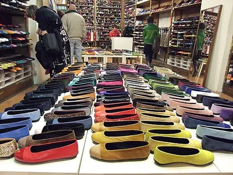 ballet flat: a type of women's flat with a very low heel, thin sole, and round toe