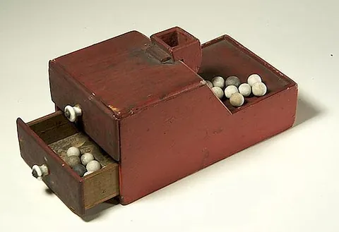 ballot: a small ball placed in a container to cast a vote; now, by extension, a piece of paper or card used...