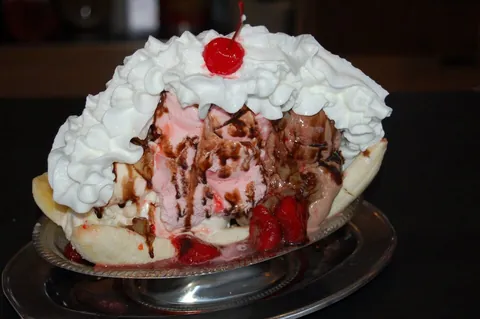 banana split: a dessert or sundae containing a banana cut in half lengthwise (split), ice cream and various...