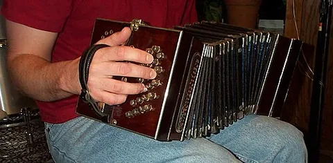 bandoneon: a small Latin American accordion played with buttons which is frequently used in tango ensembles