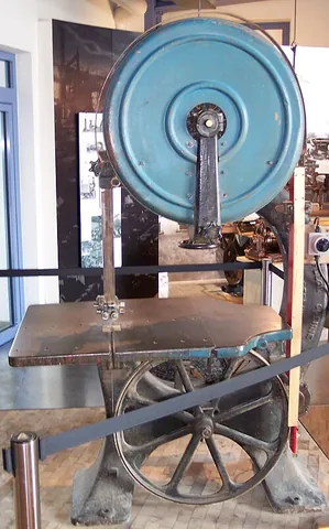 bandsaw: a powered saw whose blade is a continuous band of metal with teeth along one edge